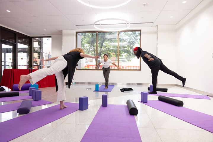 three people in a yoga class
