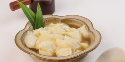 a bowl with tofu pudding with ginger syrup