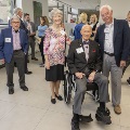 A group of people posing around Dr Tew