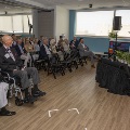 Seated guests watch the speaker at the podium
