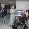 A seated man talking to a women with two other people talking