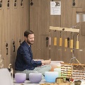 Seated man performing sound immersion surrounded by instruments