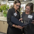 Two women looking a folder together