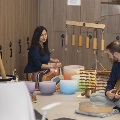 A man and a woman perform sound immersion with various instruments