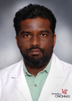 Image of Pattabhi Prasad with UC lab coat