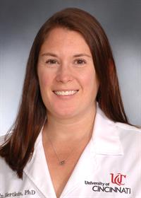 Dr. Erin Hertlein Photo of Dr. Erin Hertlein in a UC lab coat