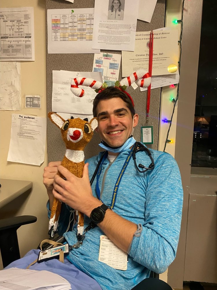 Resident Holding Doll Photograph of a resident physician holding a doll