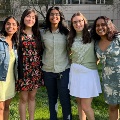 5 women standing on grass